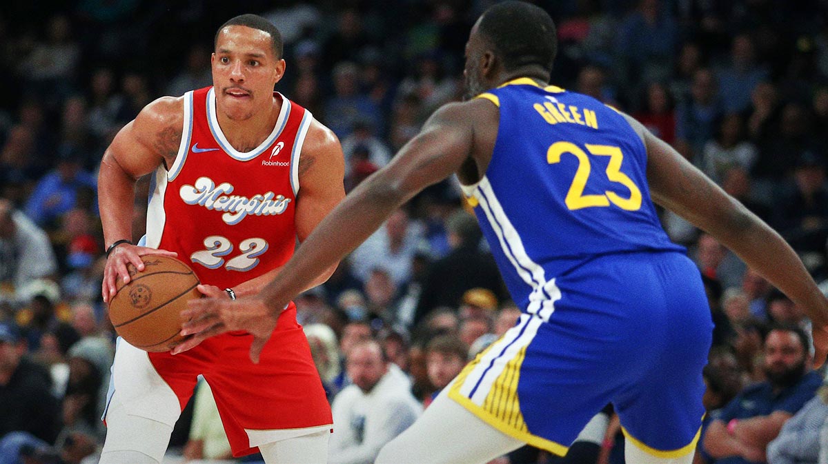 Memphis Grizzlies guard Desmond Bane (22) handles the ball as Golden State Warriors forward Draymond Green (23) defends during the second quarter at FedExForum.
