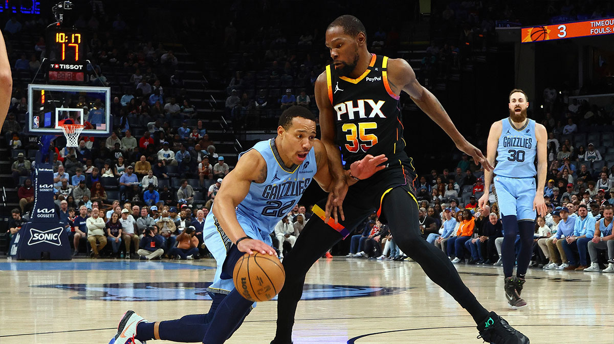 Memphis Grizzlies guard Desmond Bane (22) drives to the basket as Phoenix Suns forward Kevin Durant (35) defends during the first quarter at FedExForum.