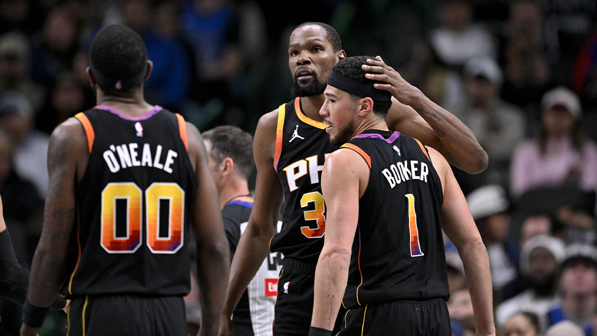 Phoenix Suns forward Kevin Durant (35) helps up guard Devin Booker (1) from the floor during the second half of the game against the Dallas Mavericks at the American Airlines Center.
