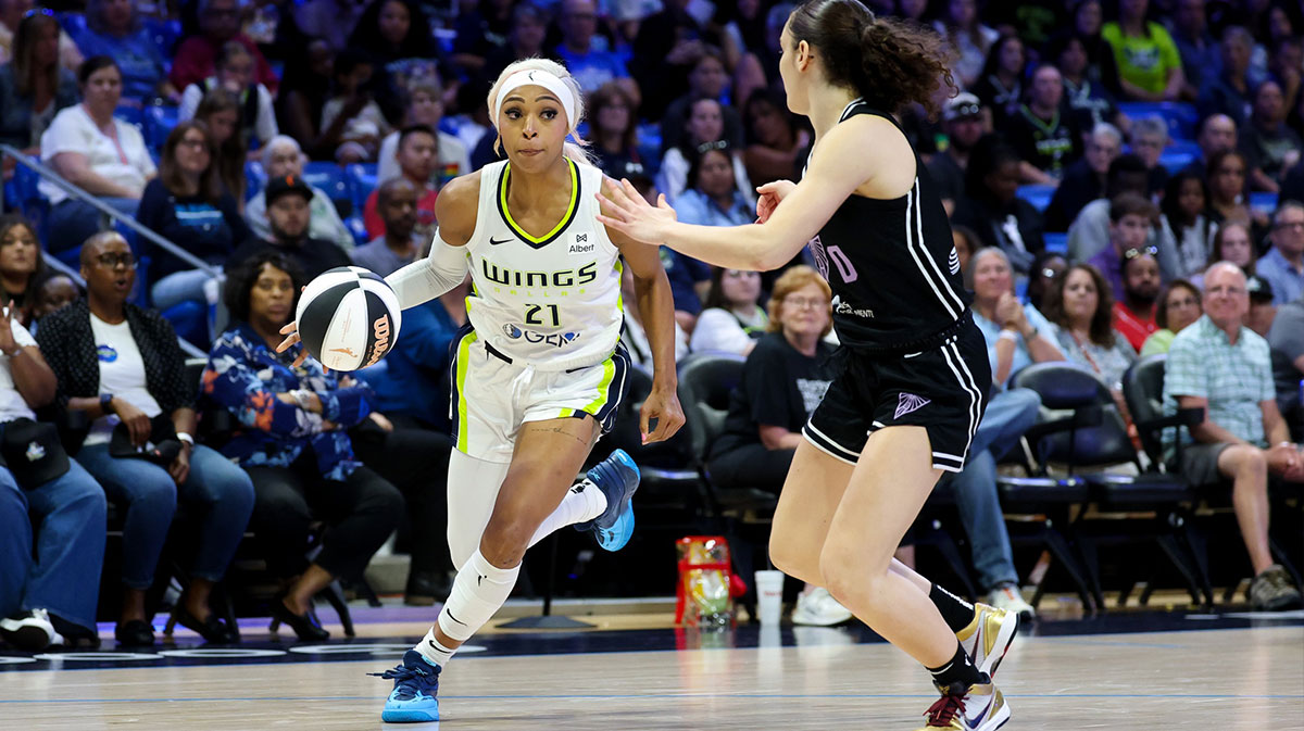 Dallas Wings guard DiJonai Carrington (21) drives to the basket as Golden State Valkyries guard Carla Leite (0) defends during the second half at College Park Center.