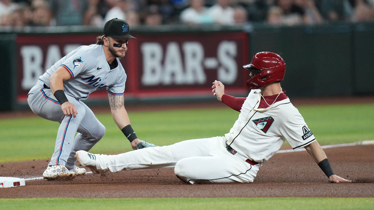 Arizona Diamondbacks base runner Randal Grichuk (15) slides safely into third base past Miami Marlins infielder Connor Norby (1) at Chase Field on Saturday in Phoenix.