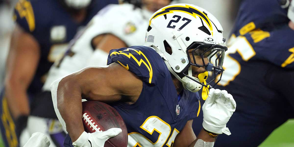 Los Angeles Chargers running back J.K. Dobbins (27) carries the ball against the Baltimore Ravens in the first half.