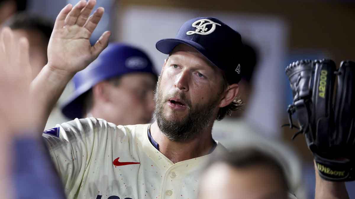 Los Angeles Dodgers starting pitcher Clayton Kershaw high fives teammates after coming off the field during the seventh inning of a baseball game against the San Francisco Giants at Dodger Stadium.