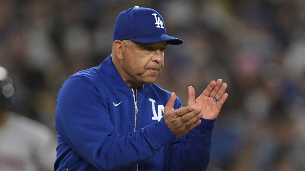 Los Angeles Dodgers manager Dave Roberts (30) walks to the mound for a pitching change in the eighth inning against the Arizona Diamondbacks at Dodger Stadium.