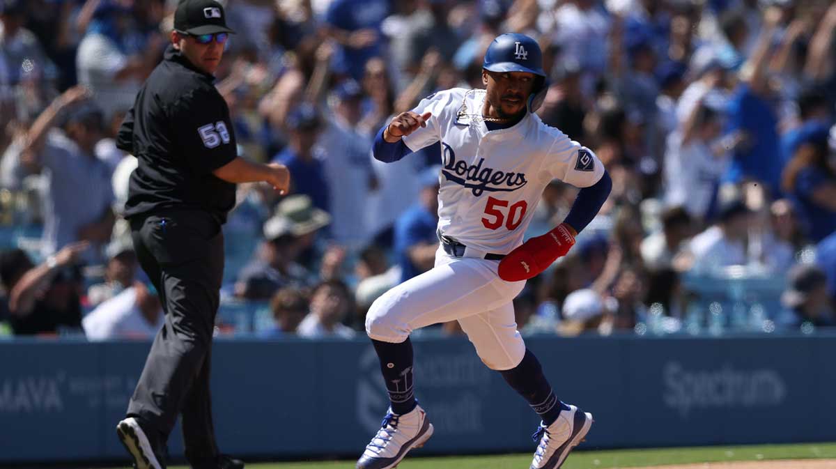 Los Angeles Dodgers shortstop Mookie Betts (50) rounds third and scores during the eighth inning against the New York Mets at Dodger Stadium.