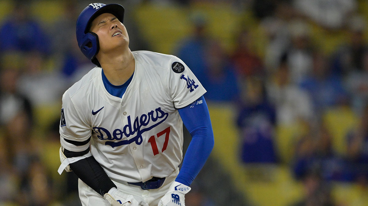 Los Angeles Dodgers designated hitter Shohei Ohtani (17) reacts after he was hit by a pitch in the ninth inning against the San Diego Padres at Dodger Stadium.