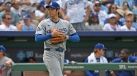Los Angeles Dodgers designated hitter Shohei Ohtani (17) walks out to pitch in the second inning against the Kansas City Royals at Kauffman Stadium.
