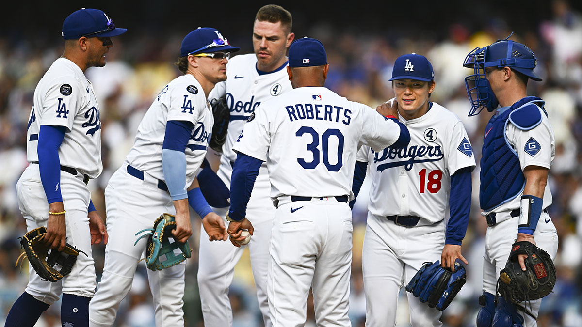 Los Angeles Dodgers manager Dave Roberts (30) relieves starting pitcher Yoshinobu Yamamoto (18) at the mount with second baseman Enrique Hernandez (8), first baseman Freddie Freeman (5), shortstop Miguel Rojas (72), and catcher Will Smith (16) against the New York Yankees during the fourth inning at Dodger Stadium.