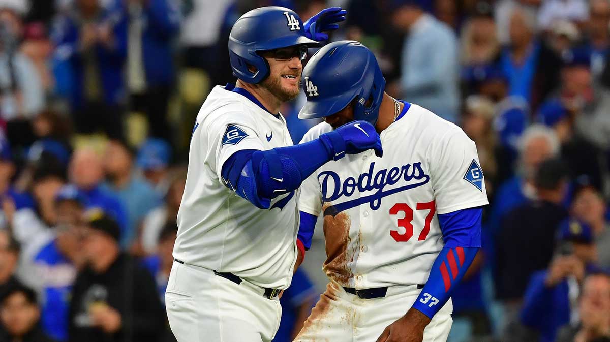 Los Angeles Dodgers third base Max Muncy (13) reacts with outfielder Teoscar Hernandez (37) after hitting a two run home run against the New York Mets during the first inning at Dodger Stadium.
