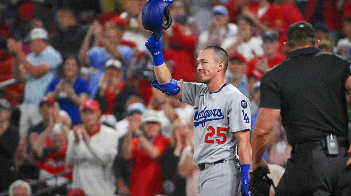 Los Angeles Dodgers second baseman Tommy Edman (25) salutes the fans as he receives a standing ovation in his return to St. Louis before his first at bat against the St. Louis Cardinals at Busch Stadium.