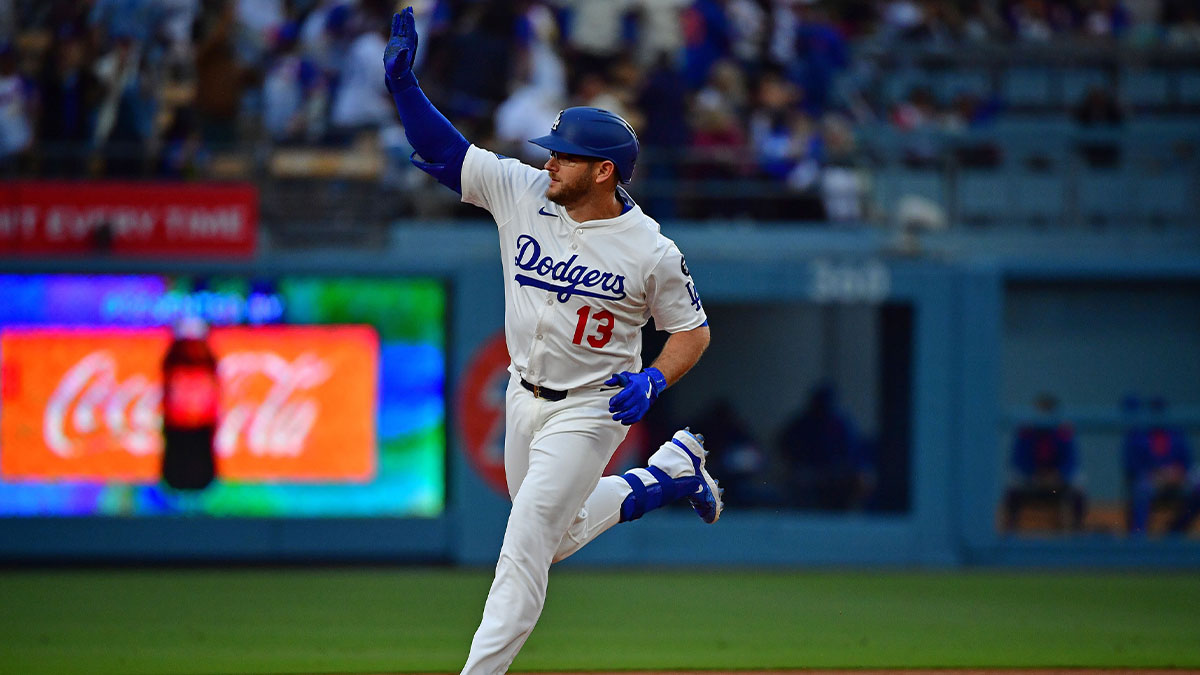 Los Angeles Dodgers third base Max Muncy (13) reacts after hitting a two run home run against the New York Mets during the first inning at Dodger Stadium.