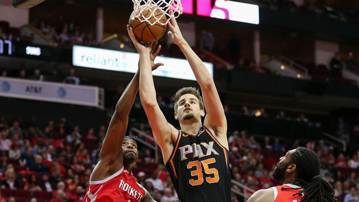Phoenix Suns forward Dragan Bender (35) shoots the ball against Houston Rockets forward Danuel House Jr. (4) and center Nene Hilario (42) during the third quarter at Toyota Center.