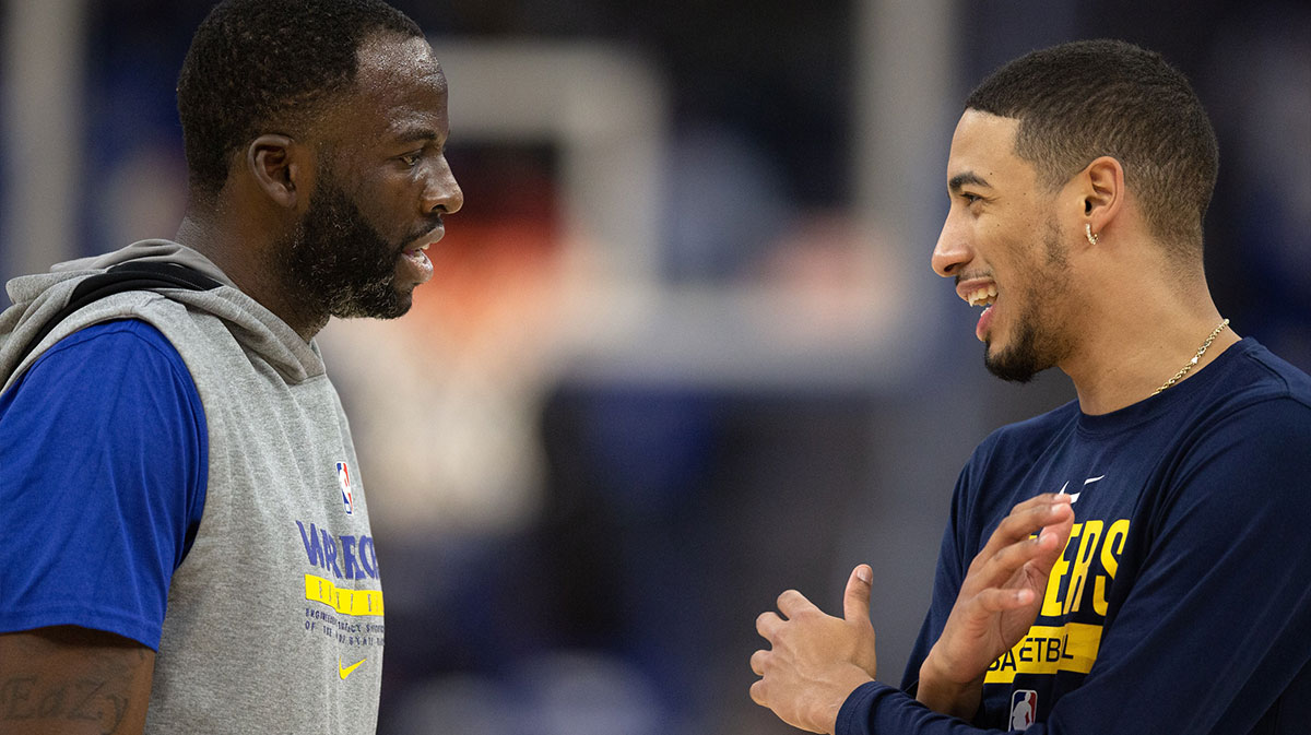 Golden State Warriors forward Draymond Green (23) and Indiana Pacers guard Tyrese Haliburton (0) chat before a game at Chase Center.