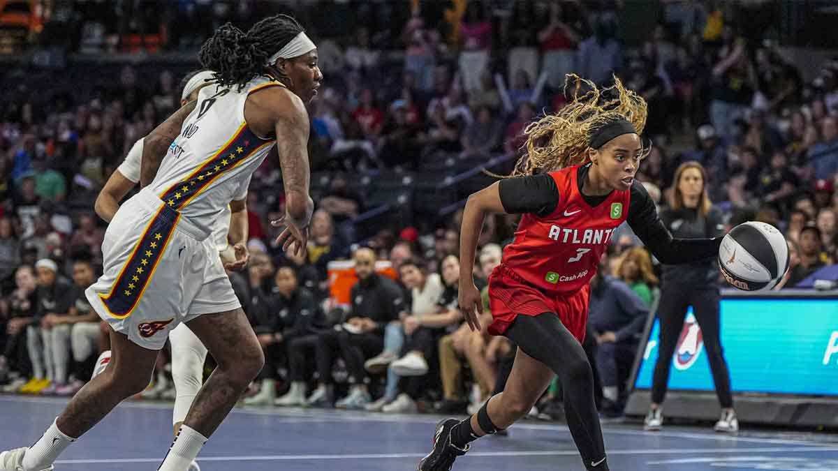 Atlanta Dream guard Jordin Canada (3) dribbles past Indiana Fever forward Natasha Howard (6) during the first half at Gateway Center Arena at College Park.