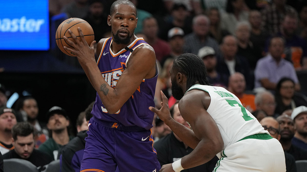 Phoenix Suns forward Kevin Durant (35) shields the ball from Boston Celtics guard Jaylen Brown (7) during the first half at Footprint Center.