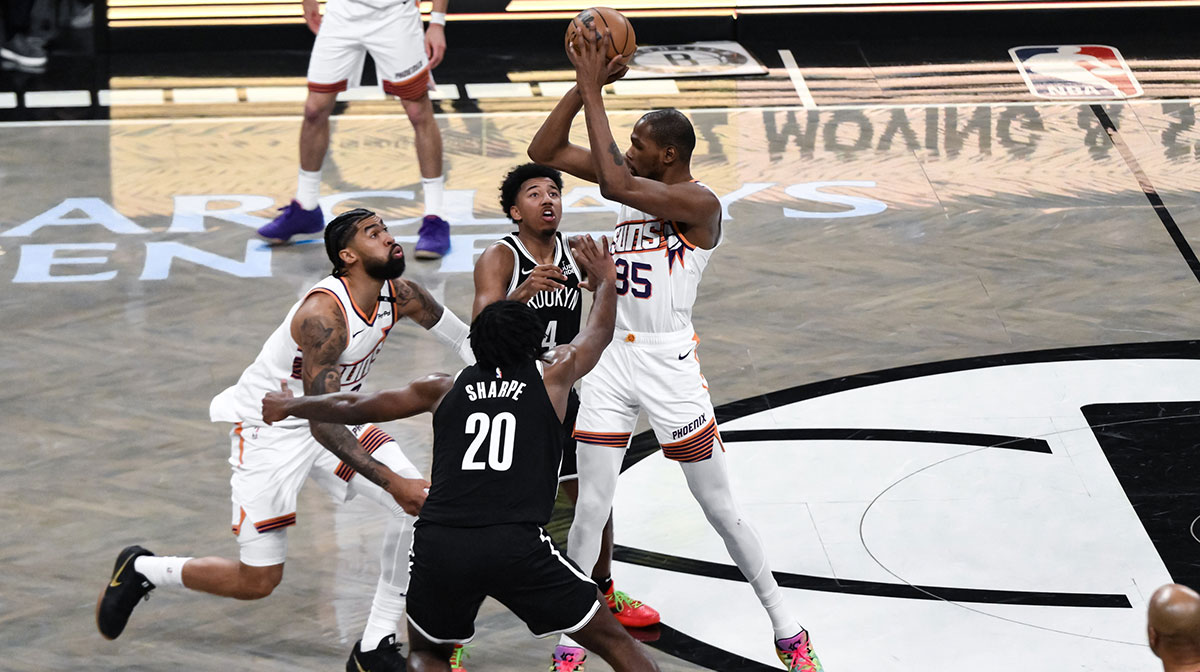Phoenix Suns forward Kevin Durant (35) looks to pass the ball as Brooklyn Nets guard Reece Beekman (4) and Brooklyn Nets center Day'Ron Sharpe (20) defend during the first half at Barclays Center.