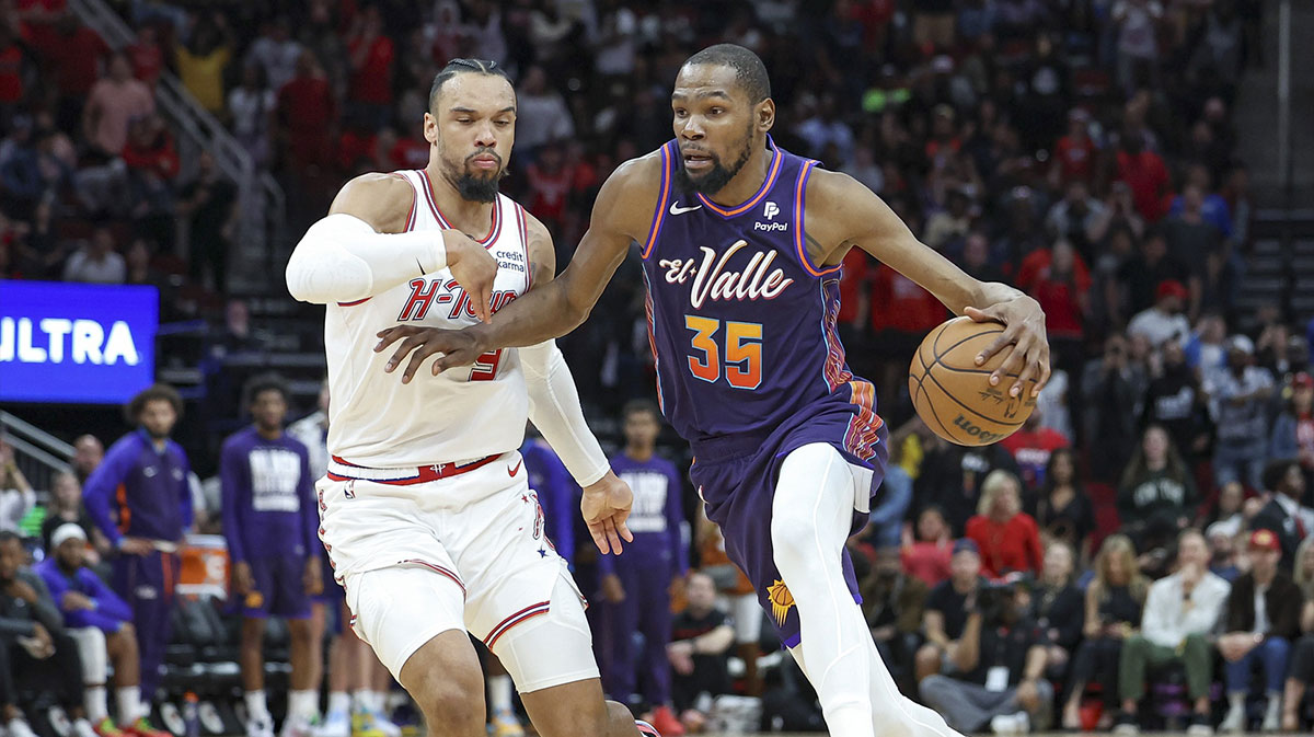 Phoenix Suns forward Kevin Durant (35) drives with the ball as Houston Rockets forward Dillon Brooks (9) defends during the fourth quarter at Toyota Center.