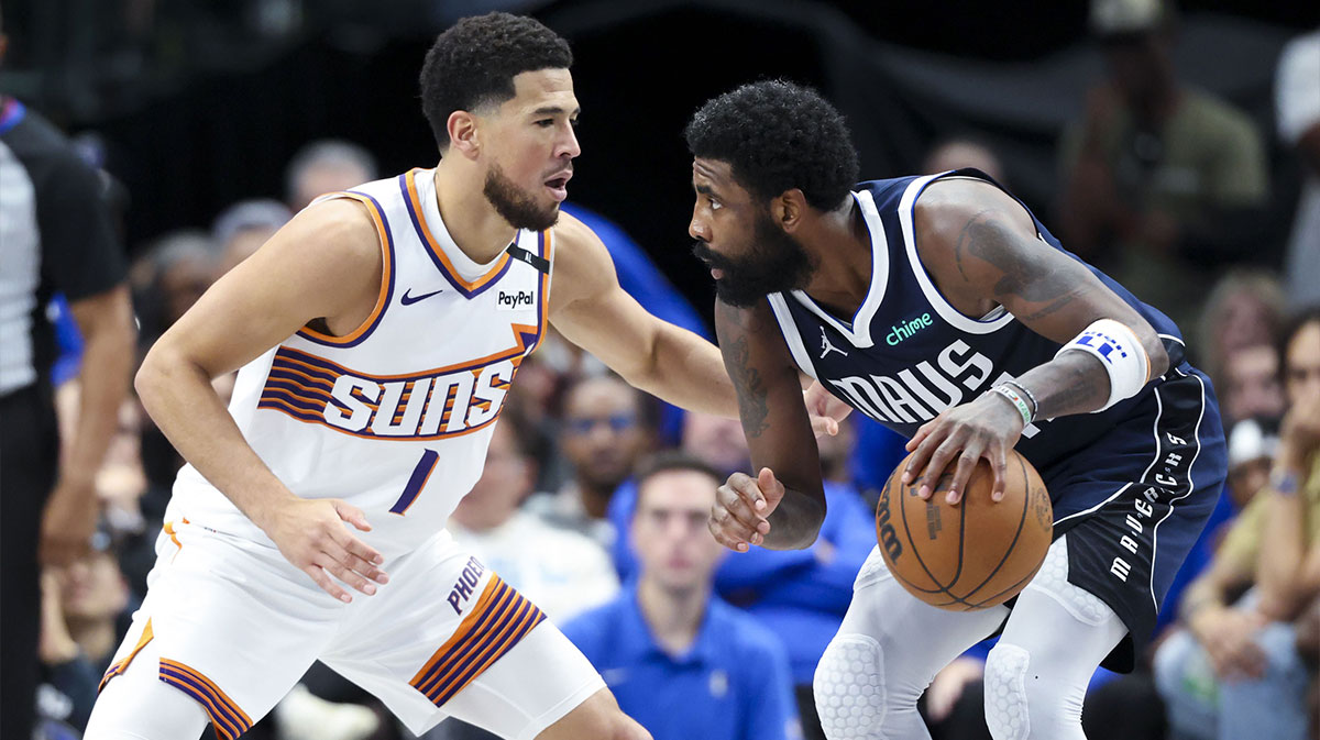 Dallas Mavericks guard Kyrie Irving (11) controls the ball as Phoenix Suns guard Devin Booker (1) defends during the third quarter at American Airlines Center.