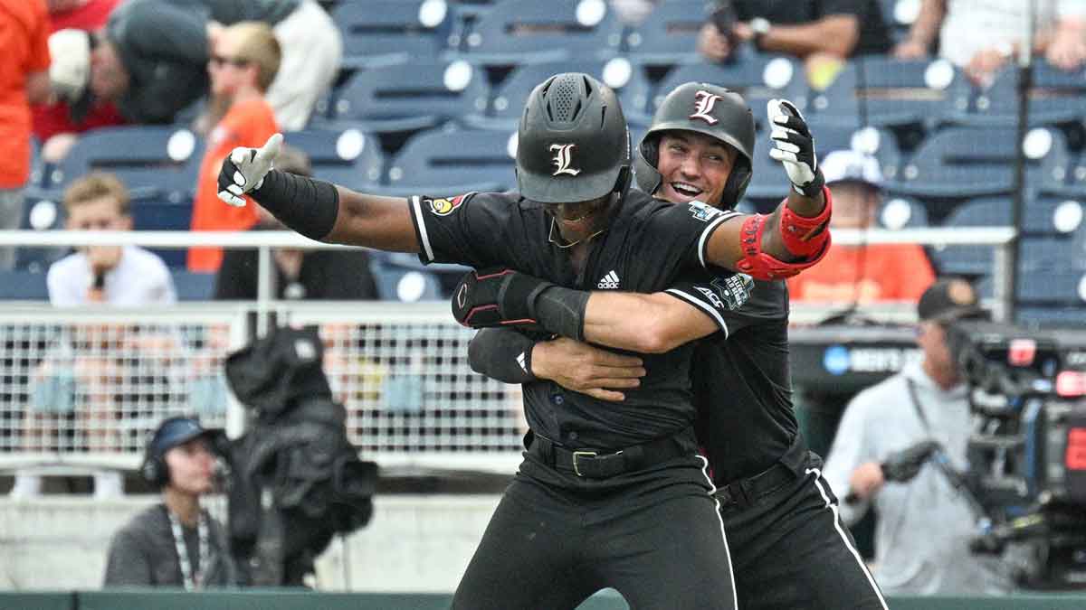 Louisville Cardinals third baseman Jake Munroe (20) hugs right fielder Eddie King Jr. (42) after King's sacrife fly drives in the winning run against the Oregon State Beavers at Charles Schwab Field.