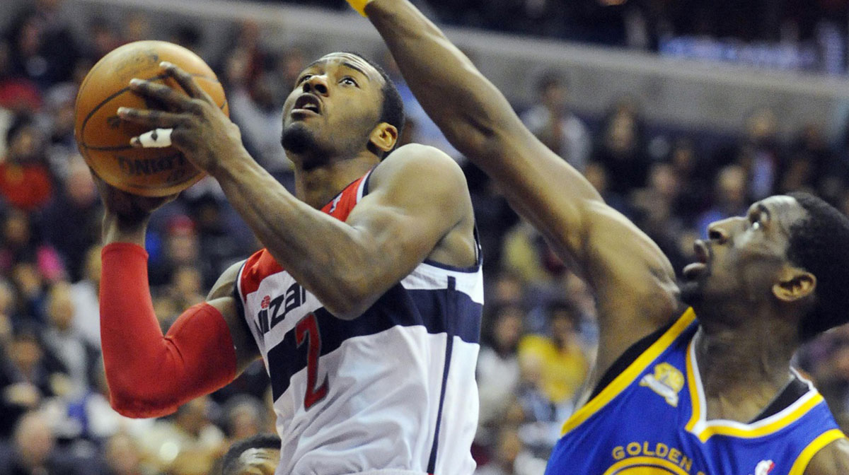 Washington Wizards guard John Wall (2) drives to the basket while defended by Golden State Warriors power forward Ekpe Udoh (20) during the first half at the Verizon Center.