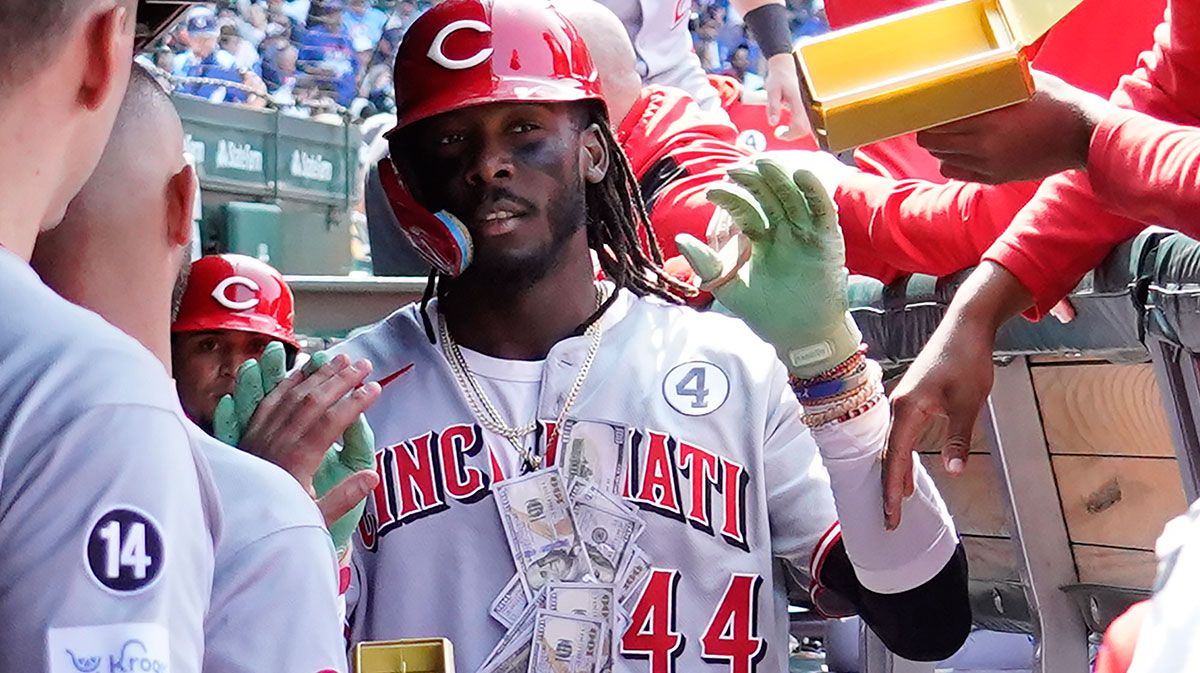 Cincinnati Reds shortstop Elly De La Cruz (44) is greeted in the dugout after hitting two-run home run against the Chicago Cubs during the sixth inning at Wrigley Field.