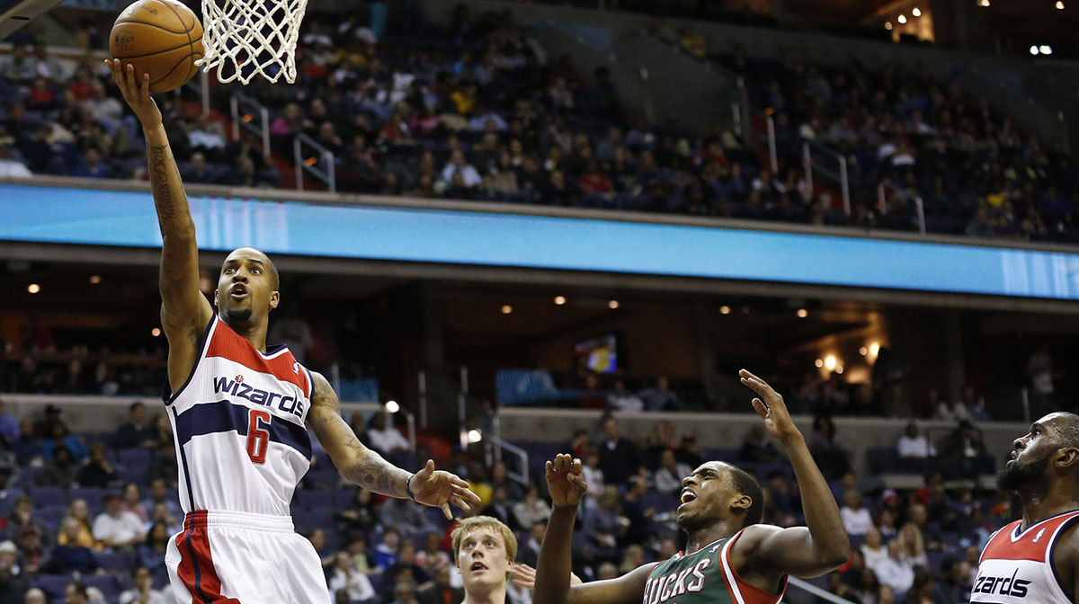 Washington Wizards point guard Eric Maynor (6) shots the ball as Milwaukee Bucks power forward Khris Middleton (22) looks on in the second quarter at Verizon Center. The Bucks won 109-105 in overtime.