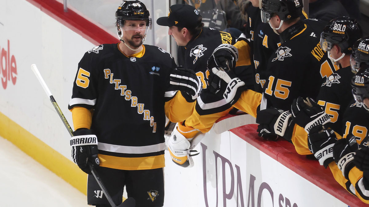 Pittsburgh Penguins defenseman Erik Karlsson (65) celebrates his 200th career NHL goal with the Penguins bench against the Chicago Blackhawks during the second period at PPG Paints Arena.