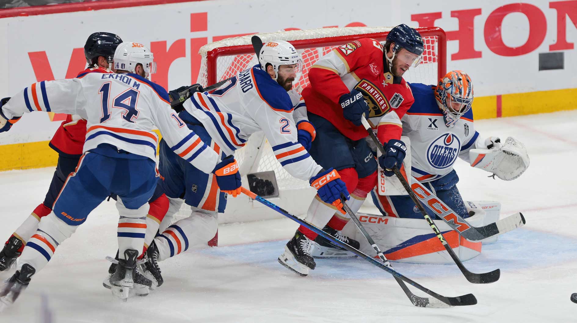 Florida Panthers center Carter Verhaeghe (23) goes after the puck defended by Edmonton Oilers defenseman Evan Bouchard (2) and goaltender Stuart Skinner (74) during the third period in game six of the 2025 Stanley Cup Final at Amerant Bank Arena.