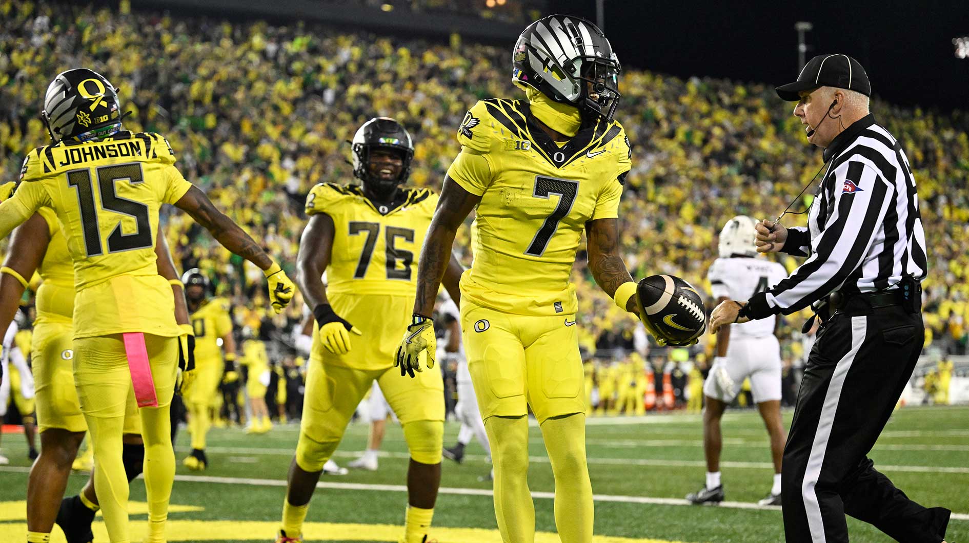 Oregon Ducks wide receiver Evan Stewart (7) gives the football to a referee after scoring a touchdown during the first half against the Michigan State Spartans at Autzen Stadium.