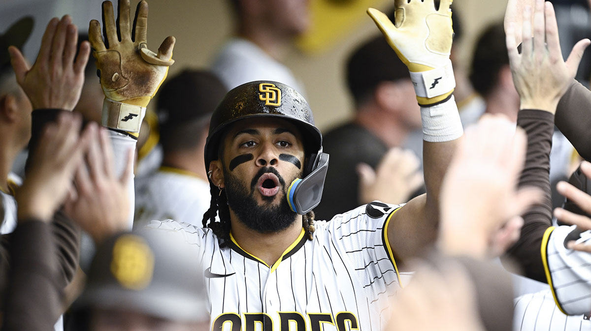Jun 21, 2025; San Diego, California, USA; San Diego Padres right fielder Fernando Tatis Jr. (23) is congratulated after hitting a three-run home run during the seventh inning against the Kansas City Royals at Petco Park. Mandatory Credit: Denis Poroy-Imagn Images