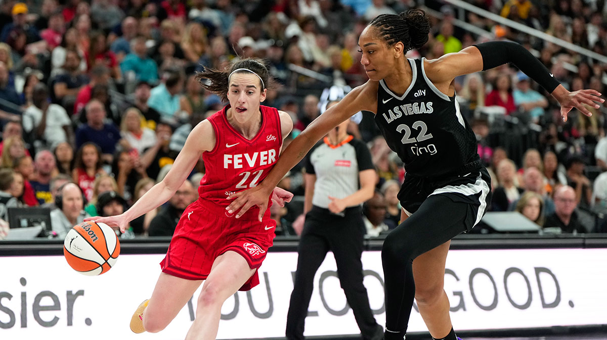 Indiana Fever guard Caitlin Clark (22) dribbles the ball against Las Vegas Aces center A'ja Wilson (22) during the second half of a WNBA basketball game at T-Mobile Arena.
