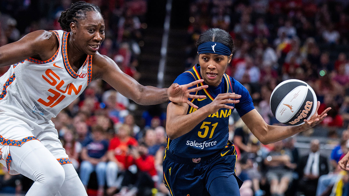 Indiana Fever guard Sydney Colson dribbles the ball while Connecticut Sun center Tina Charles defends in the first half at Gainbridge Fieldhouse.