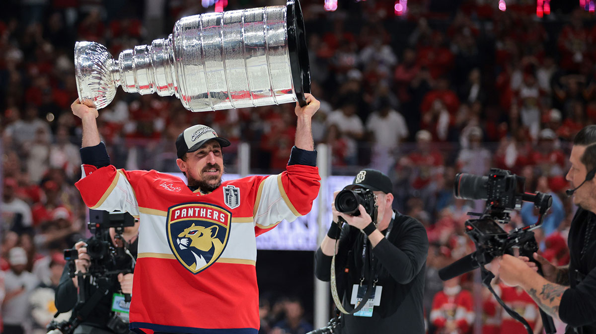 Florida Panthers center Brad Marchand (63) hoists the Stanley Cup after winning game six of the 2025 Stanley Cup Final against the Edmonton Oilers at Amerant Bank Arena.