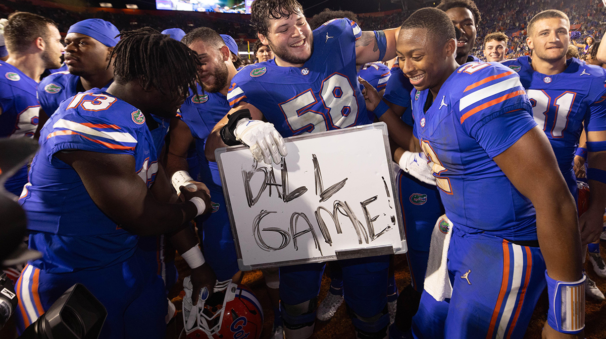 Florida Gators offensive lineman Austin Barber (58) pulls in Florida Gators quarterback DJ Lagway (2) as the Gators celebrated at Ben Hill Griffin Stadium in Gainesville, FL on Saturday, November 16, 2024. The Gators defeated the Tigers 27-16. [Doug Engle/Gainesville Sun]