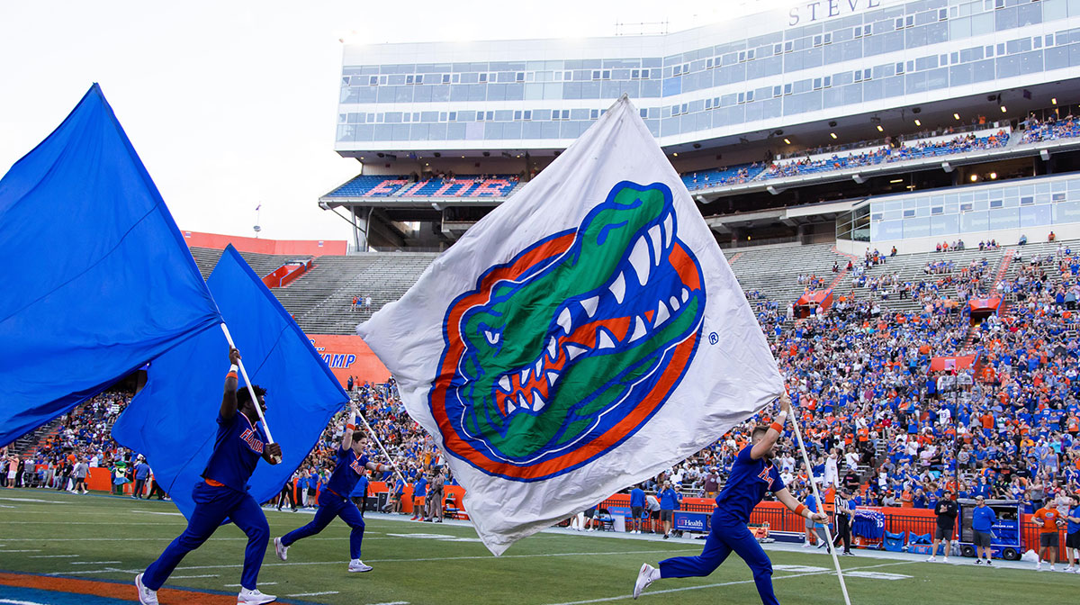 Gator fans cheer as the flags are brought onto the field during the first half of the University of Florida Orange & Blue game at Ben Hill Griffin Stadium