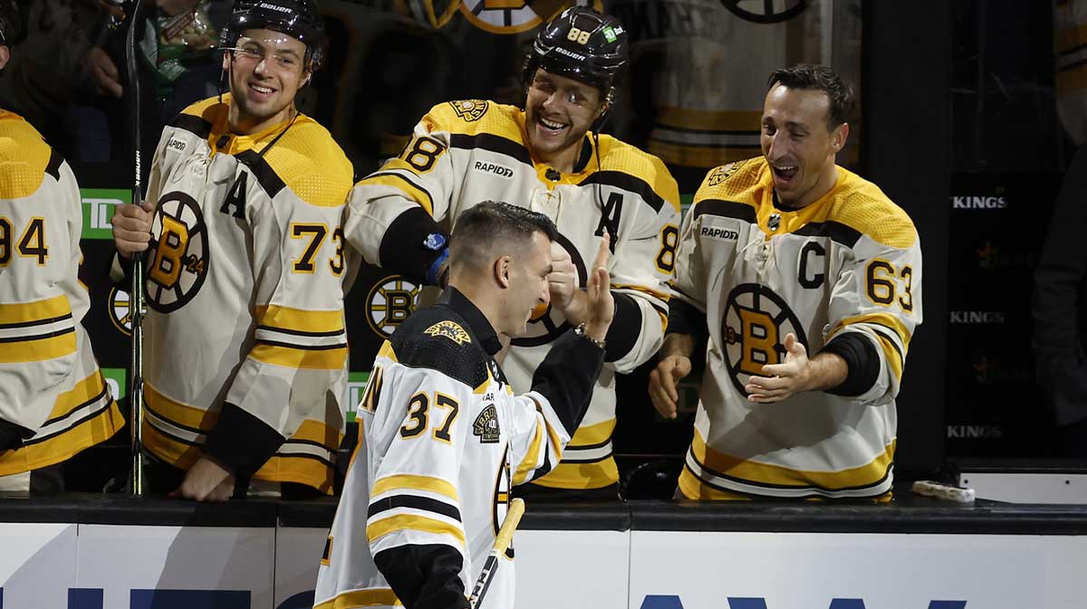Former Boston Bruins captain Patrice Bergeron greets former teammates Boston Bruins right wing David Pastrnak (88) and left wing Brad Marchand (63) before the start of Boston s 100th season in the NHL at TD Garden.