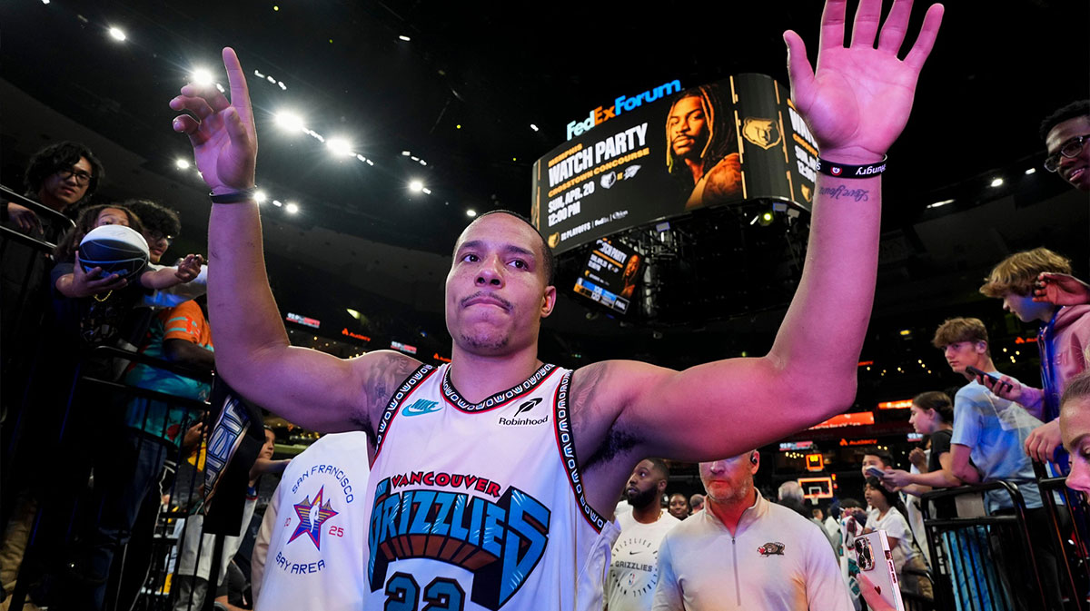 Grizzlies' Desmond Bane (22) high fives fans as he walks off the court after the Grizzlies defeated the Mavericks 120-106 in the play-in game to secure a spot in the NBA Playoffs at FedExForum.