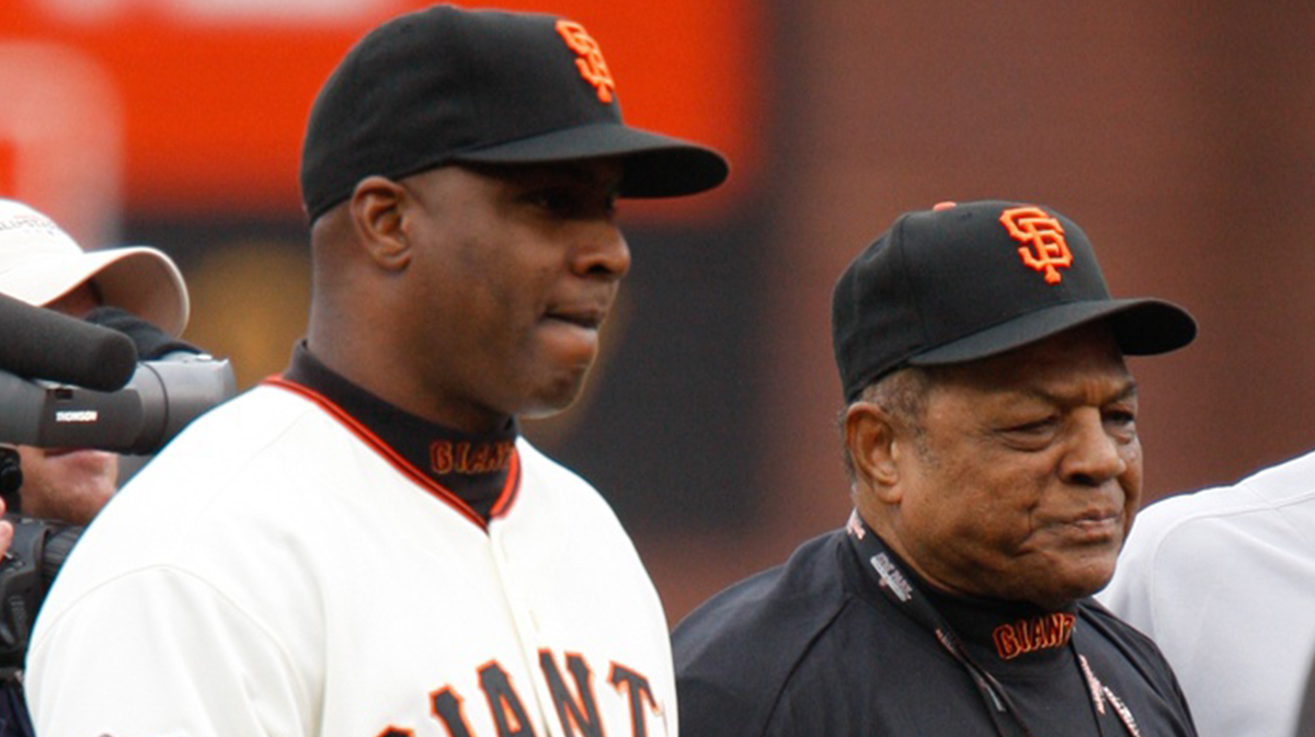 Major League Baseball All-Star Game -- Barry Bonds walks Willie Mays to a 1958 Cadillac during a pre-game tribute to Mays.