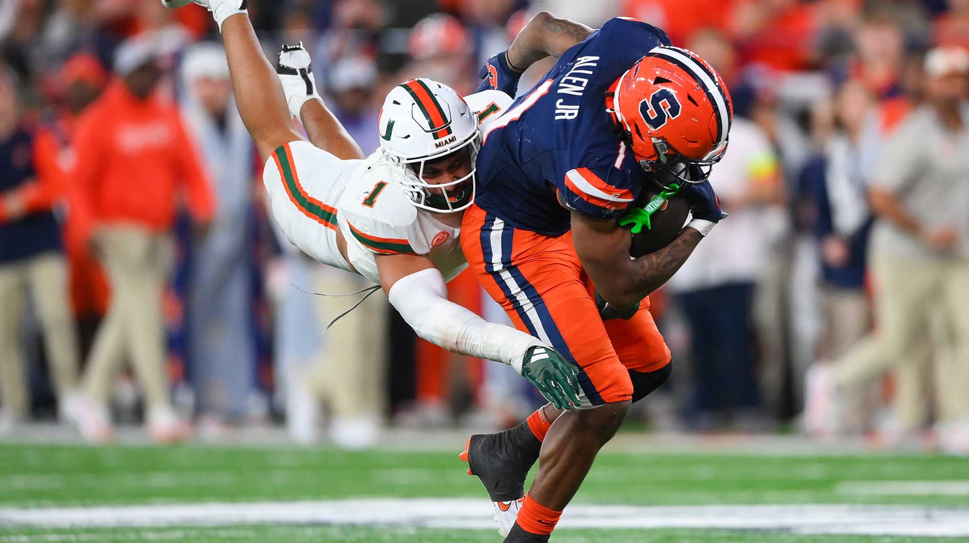Miami Hurricanes linebacker Francisco Mauigoa (1) makes a diving tackle on Syracuse Orange running back LeQuint Allen (1) during the second half at the JMA Wireless Dome.