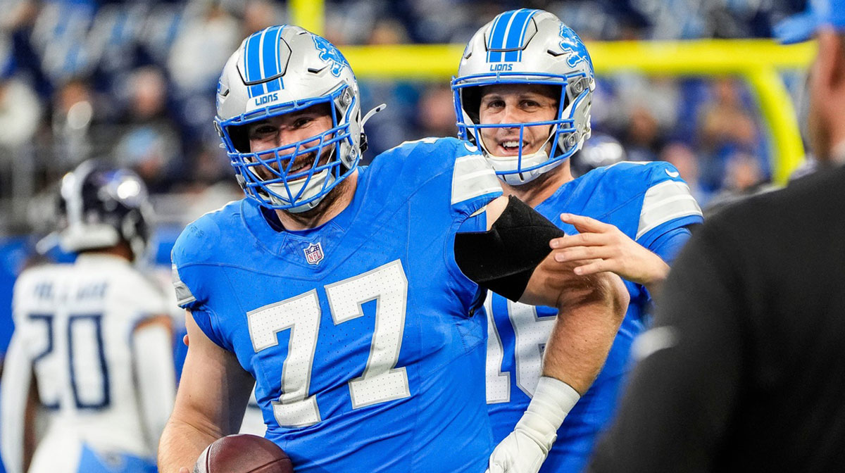 Detroit Lions quarterback Jared Goff (16) talks to center Frank Ragnow (77) during warm up before the Tennessee Titans game at Ford Field in Detroit on Sunday, Oct. 27, 2024.