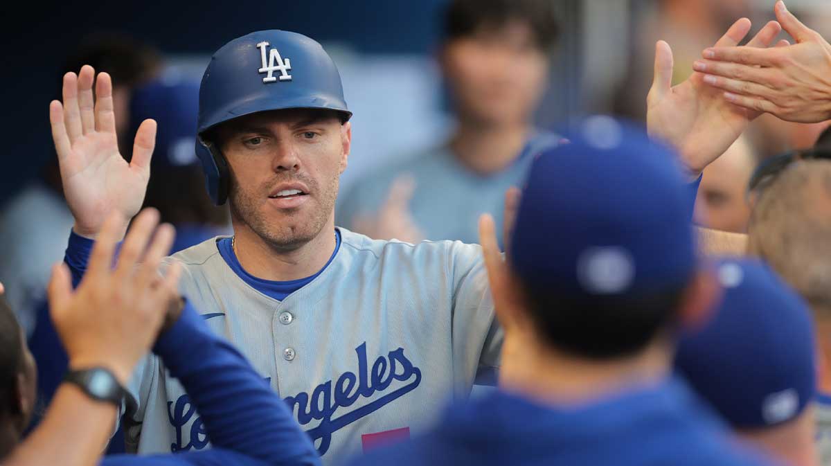May 7, 2025; Miami, Florida, USA; Los Angeles Dodgers first baseman Freddie Freeman (5) celebrates with teammates after scoring against the Miami Marlins during the seventh inning at loanDepot Park. Mandatory Credit: Sam Navarro-Imagn Images