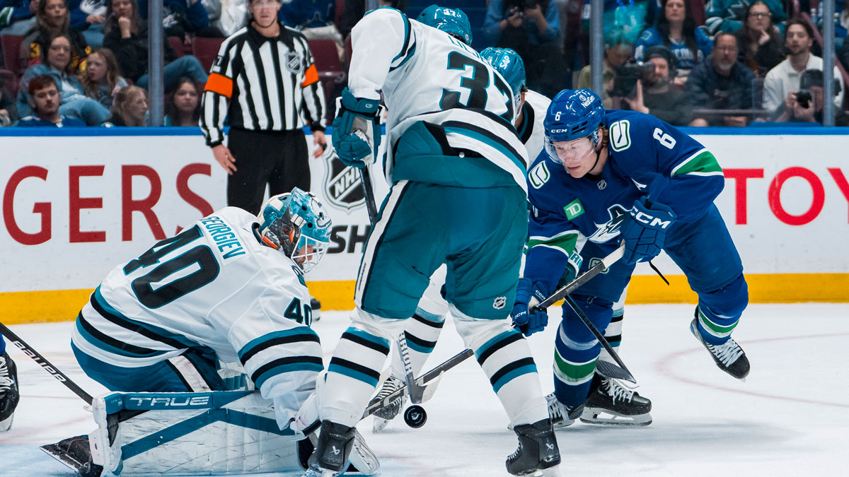 San Jose Sharks defenseman Timothy Liljegren (37) watches as goalie Alexandar Georgiev (40) makes a save on Vancouver Canucks forward Brock Boeser (6) in the second period at Rogers Arena.