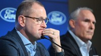Toronto Maple Leafs general manager Brad Treliving listens to a question during a media conference to introduce new head coach Craig Berube (right) at Ford Performance Centre.