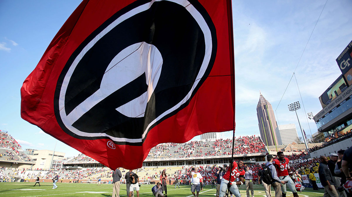 Georgia Bulldogs linebacker Jordan Jenkins (59) celebrates while waving the Georgia flag after their game against the Georgia Tech Yellow Jackets at Bobby Dodd Stadium. The Bulldogs won 13-7.