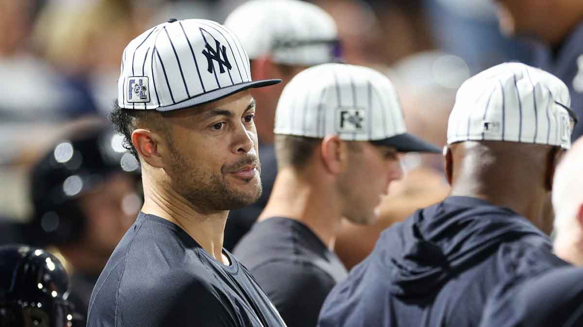 New York Yankees designated hitter Giancarlo Stanton (27) looks on from the dugout against the Philadelphia Phillies in the sixth inning during spring training.