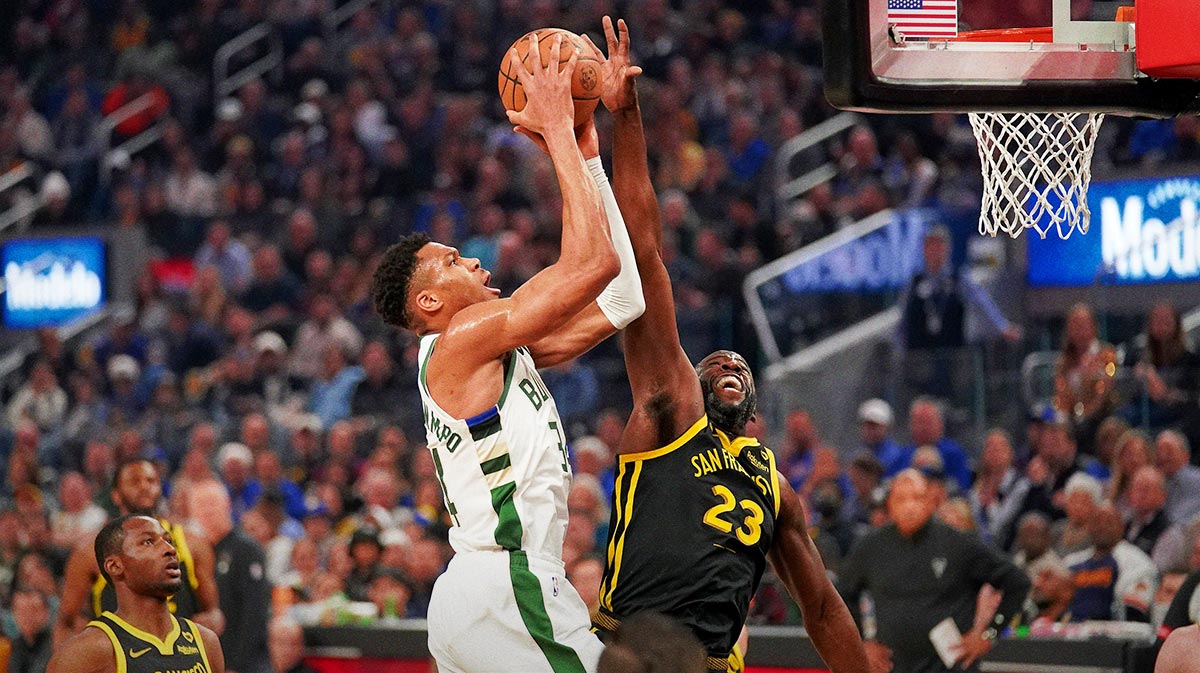 Milwaukee Bucks forward Giannis Antetokounmpo (34) is fouled by Golden State Warriors forward Draymond Green (23) in the first quarter at the Chase Center.