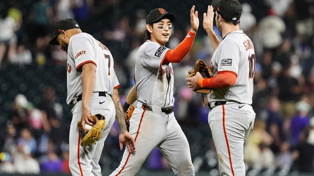 San Francisco Giants first baseman Dominic Smith (7), center fielder Jung Hoo Lee (51) and third baseman Casey Schmitt (10) celebrate defeating the Colorado Rockies at Coors Field.