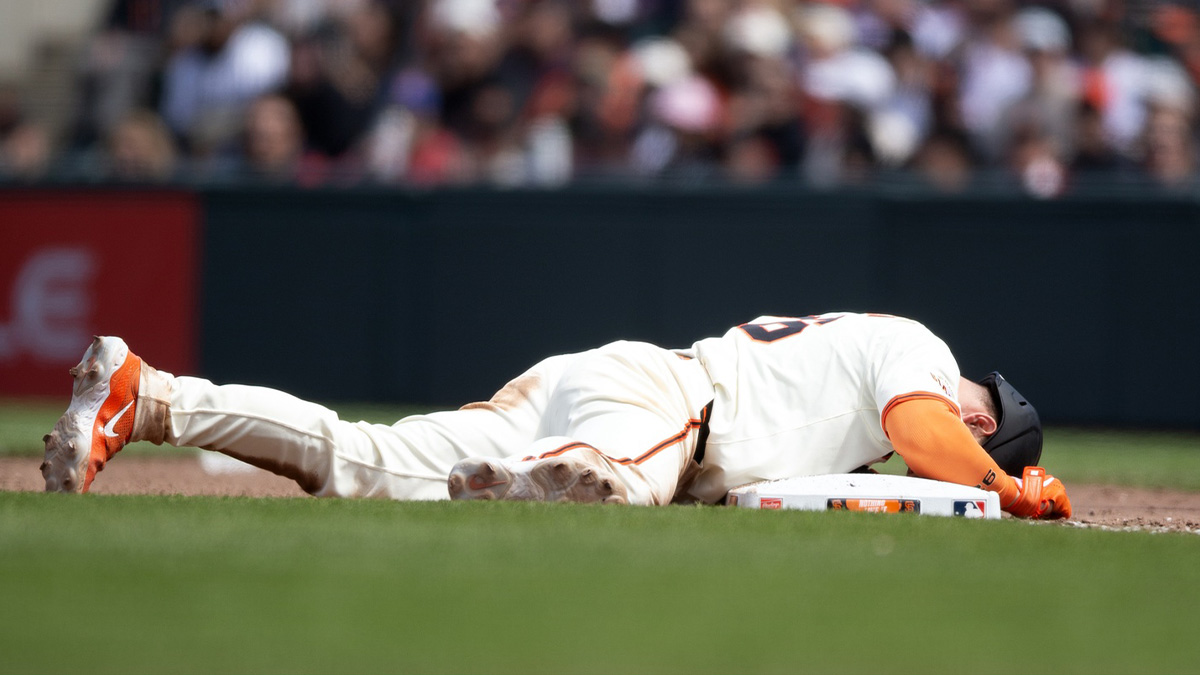 San Francisco Giants third baseman Matt Chapman (26) lays face down in pain after being picked off first base against the Atlanta Braves during the eighth inning at Oracle Park. Chapman eventually stood, and remained in the game.
