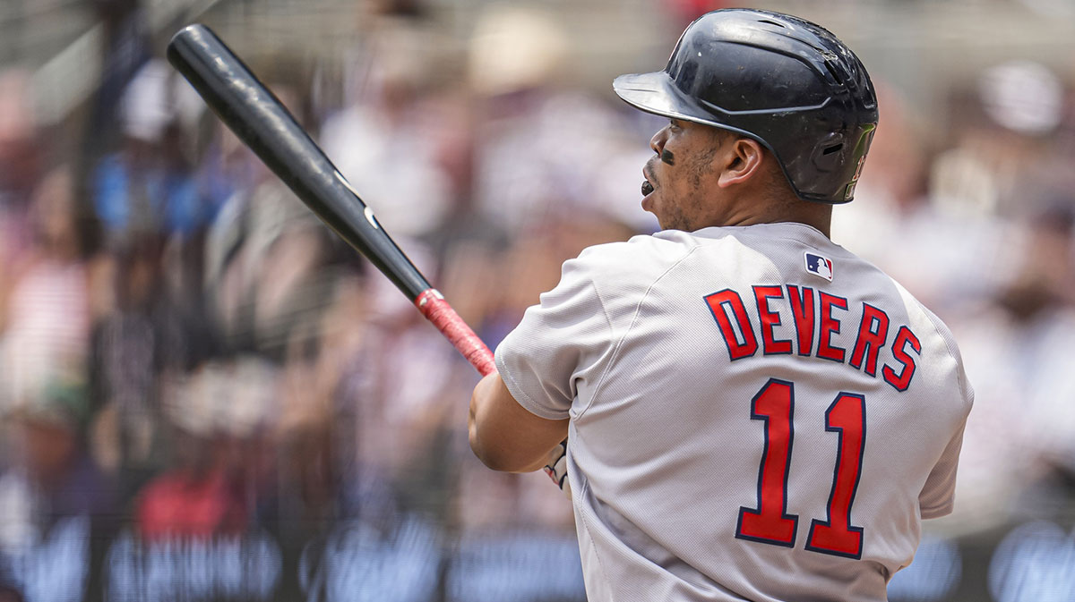 Boston Red Sox designated hitter Rafael Devers (11) follows through after hitting a double against the Atlanta Braves during the first inning at Truist Park.