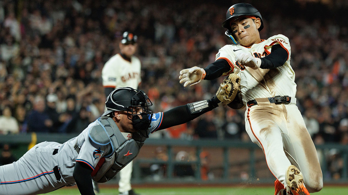 Jun 25, 2025; San Francisco, California, USA; San Francisco Giants center fielder Jung Hoo Lee (51) is tagged out at home plate by Miami Marlins catcher Nick Fortes (4) during the ninth inning at Oracle Park.